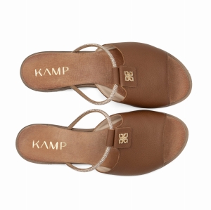 Klapki wykonane są z gładkiej skóry w ciepłym brązowym kolorze. Podeszwa jest niska i płaska. Całość ma prosty, klasyczny wygląd.