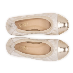 Złote skórzane baleriny. Bardzo miękkie obuwie damskie z ozdobnym złotym czubkiem. Baleriny na płaskiej podeszwie obszyte gumką. Widok z góry.